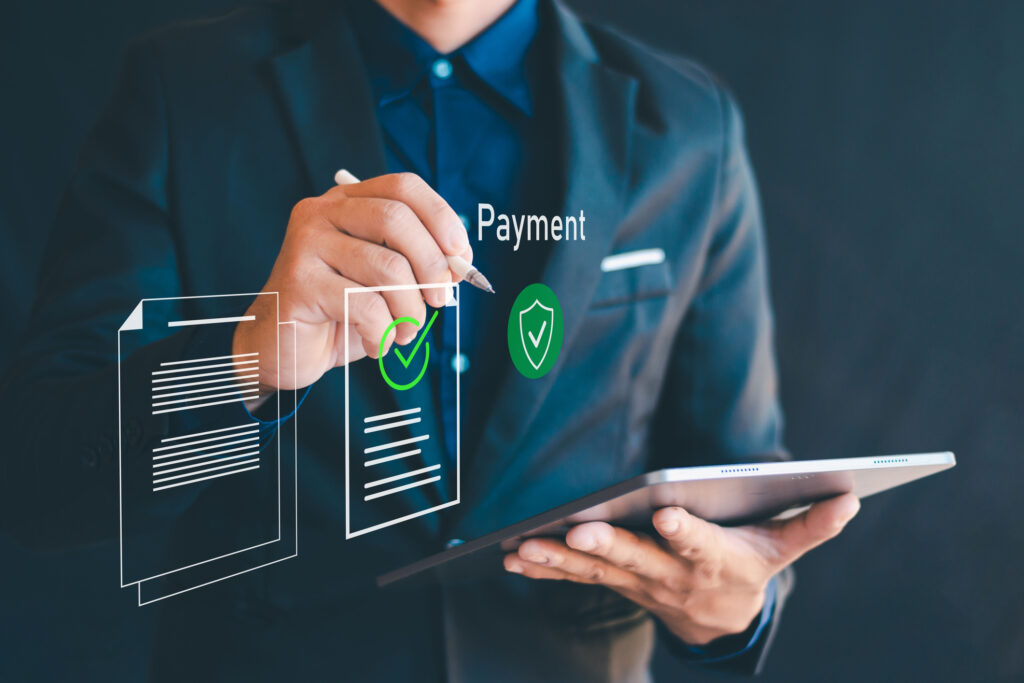 Business professional using a tablet to manage secure digital payments, representing unattended payment integration for ISVs.