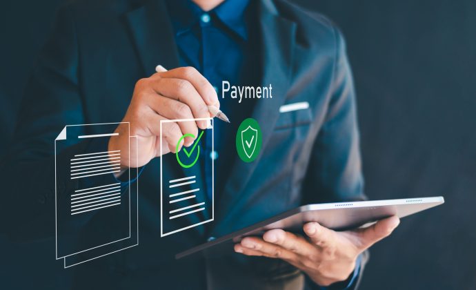 Business professional using a tablet to manage secure digital payments, representing unattended payment integration for ISVs.